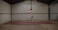 a man is standing on a mat in a room