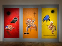 three paintings on a wall in an art gallery